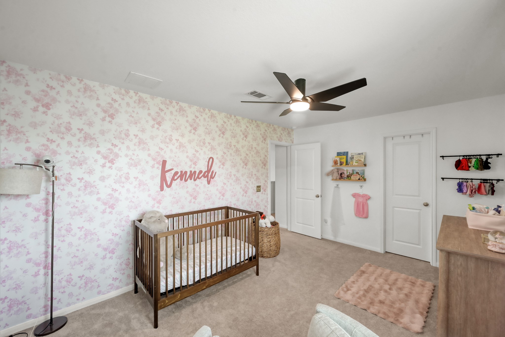 23562 Glenbuck Street Spring, TX 77373 - Photo 26 of 30 a bedroom with a bed and a chandelier