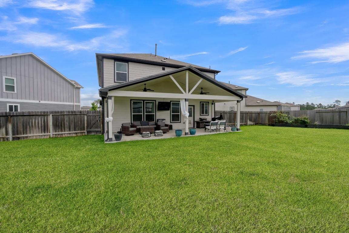 23562 Glenbuck Street Spring, TX 77373 - Photo 29 of 30 a patio with a table and chairs under an umbrella