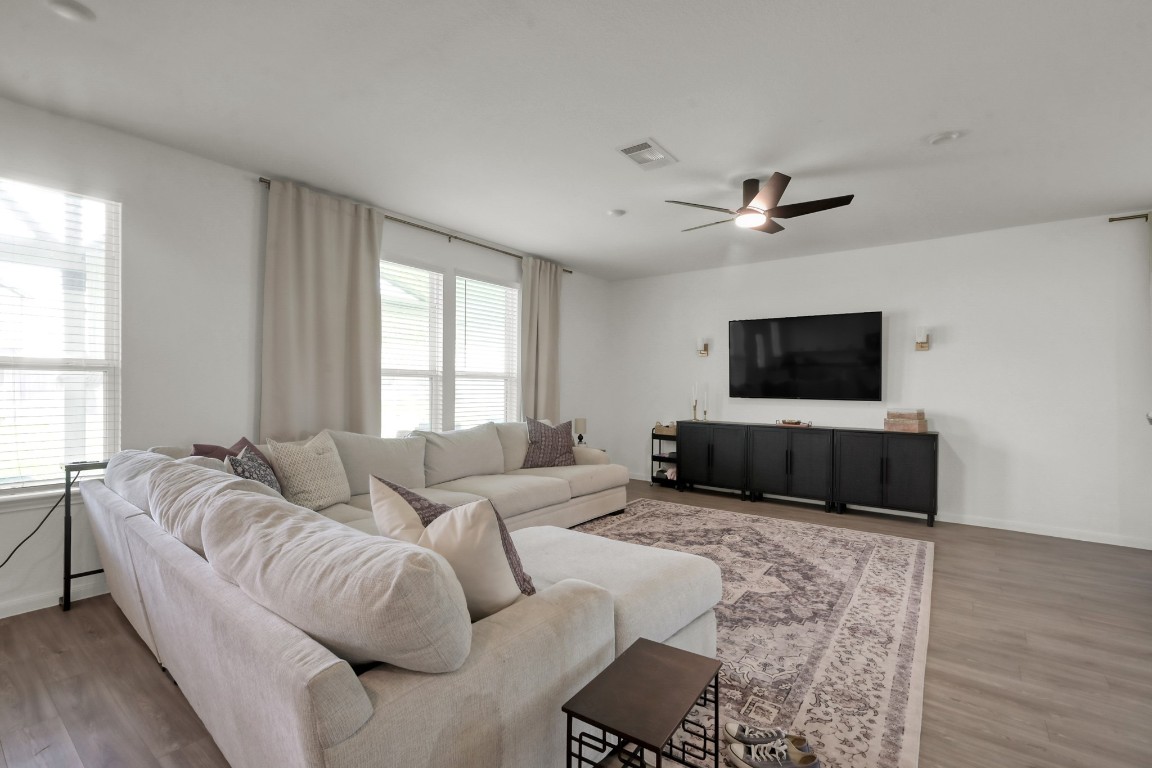 23562 Glenbuck Street Spring, TX 77373 - Photo 8 of 30 a living room with furniture and a flat screen tv