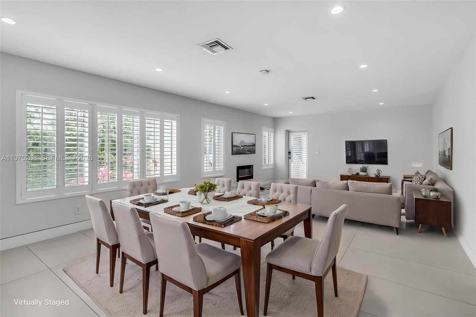 1632 Southwest 12th Street Miami, FL 33135 - Photo 11 of 43 a view of a dining room with furniture and a flat screen tv