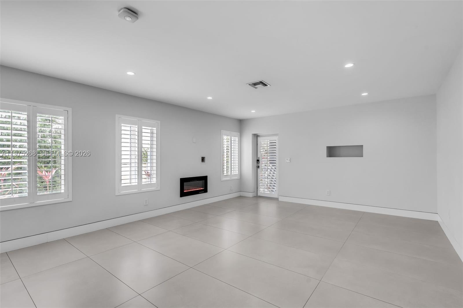 1632 Southwest 12th Street Miami, FL 33135 - Photo 12 of 43 an empty room with windows and fireplace