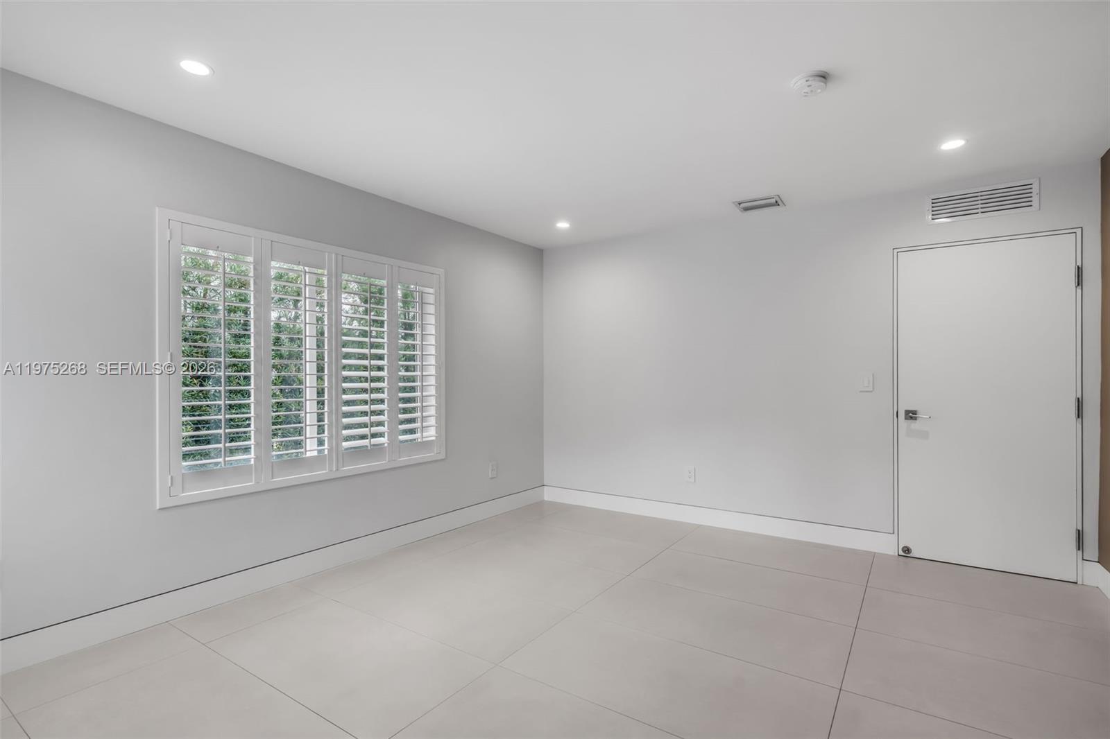 1632 Southwest 12th Street Miami, FL 33135 - Photo 18 of 43 a view of an empty room with a window