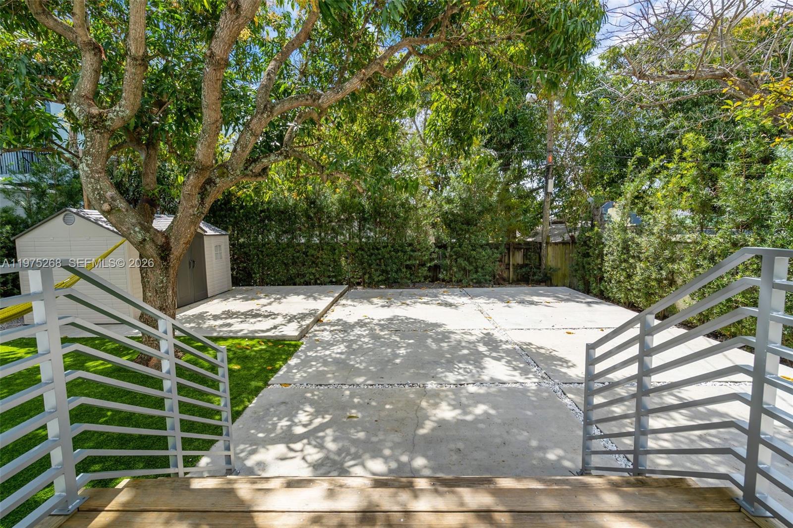 1632 Southwest 12th Street Miami, FL 33135 - Photo 29 of 43 a backyard of a house with large trees and plants