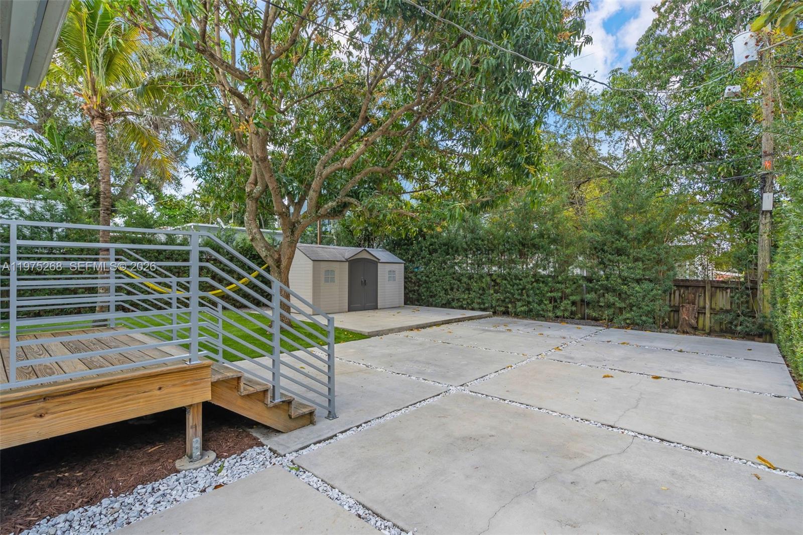 1632 Southwest 12th Street Miami, FL 33135 - Photo 30 of 43 a backyard of a house with table and chairs