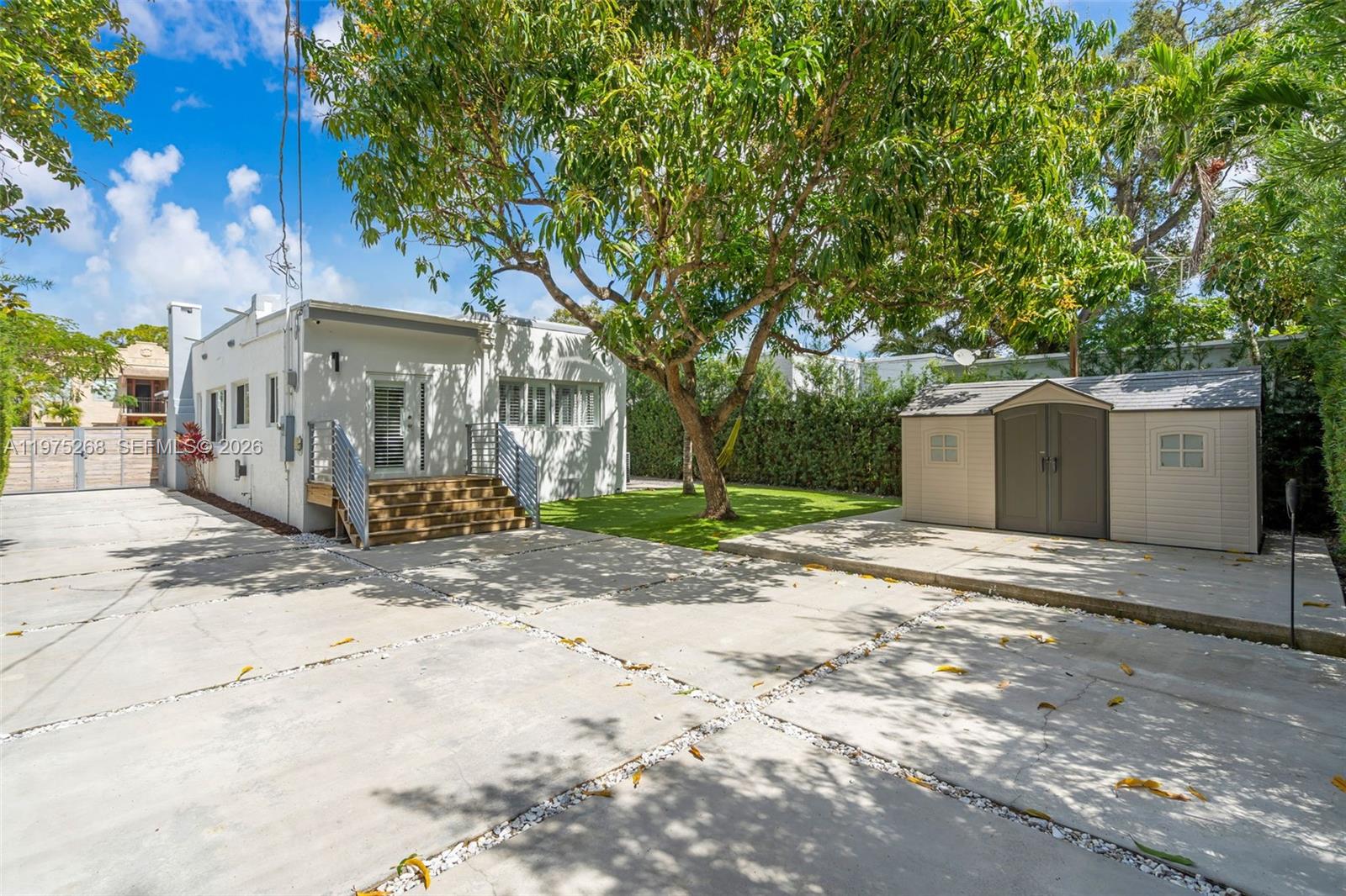 1632 Southwest 12th Street Miami, FL 33135 - Photo 31 of 43 a front view of a house with a yard and garage