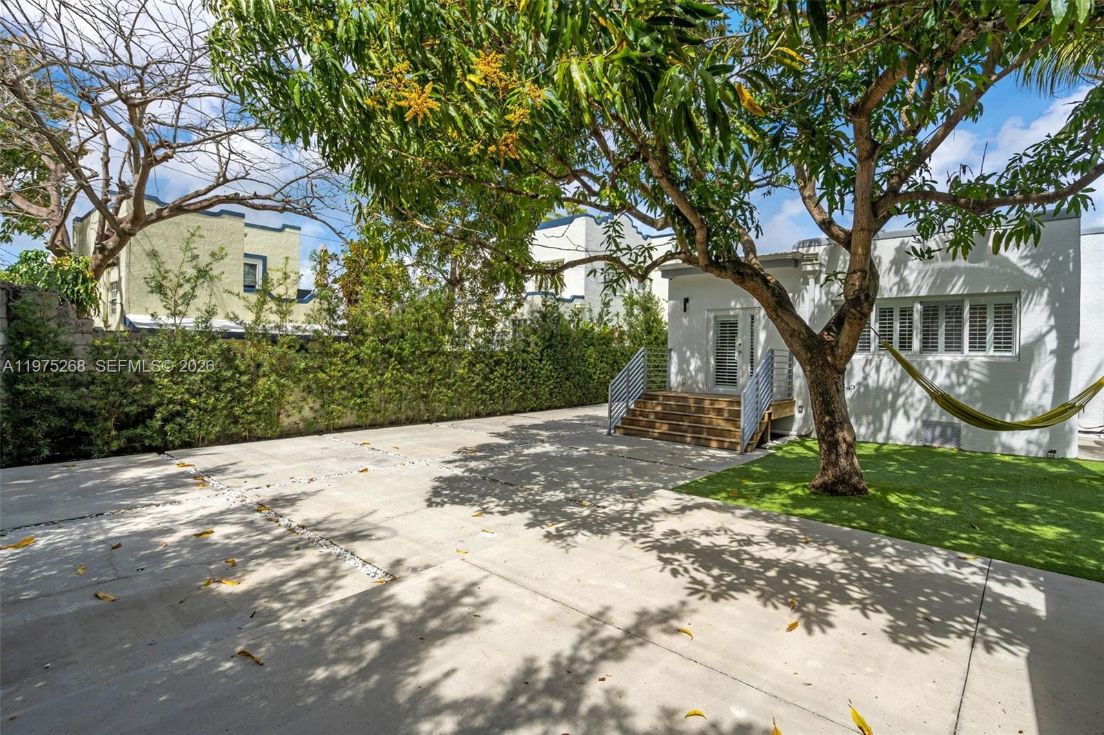 1632 Southwest 12th Street Miami, FL 33135 - Photo 32 of 43 a view of a yard with plants and a large tree