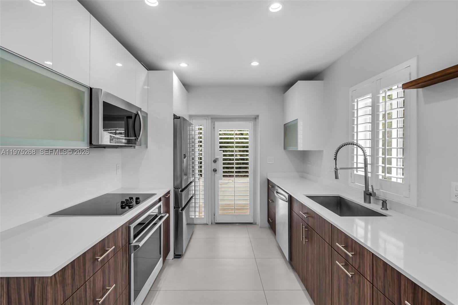 1632 Southwest 12th Street Miami, FL 33135 - Photo 5 of 43 a kitchen with granite countertop a stove and a sink