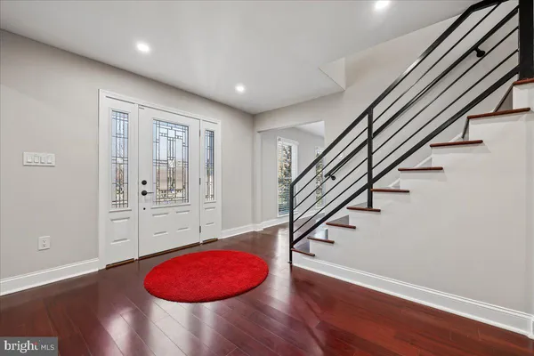 a living room with furniture a fireplace and a wooden floor