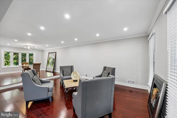 a bedroom with a large bed and ceiling fan