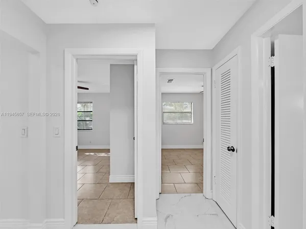 a large kitchen with granite countertop a large counter top stainless steel appliances and cabinets