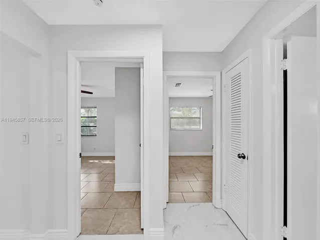 a large kitchen with granite countertop a large counter top stainless steel appliances and cabinets