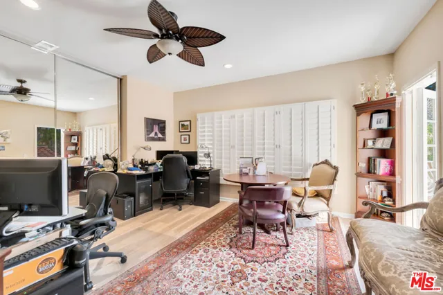 a living room filled with furniture windows and a flat screen tv