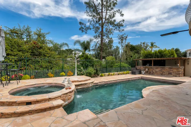 a view of a swimming pool and lounge chair