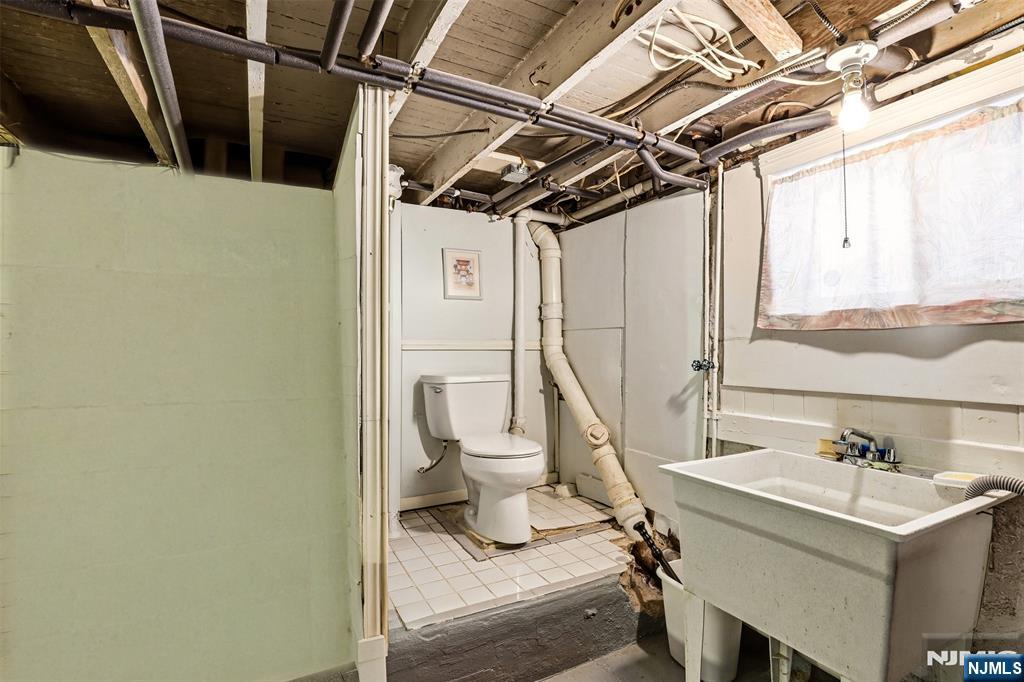 332 Riverside Avenue Lyndhurst, NJ 07071 - Photo 29 of 31 a bathroom with a sink a toilet and a tub