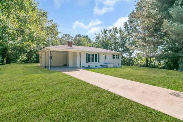 a view of house with a big yard