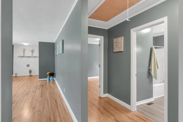 a view of a bedroom with wooden floor and a window