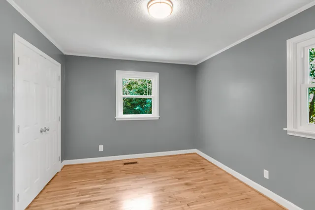 a bathroom with a toilet a sink and a window