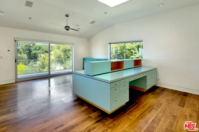 a bathroom with a tub a sink and a large window