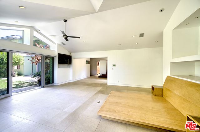 a view of an empty room with a window and pool table