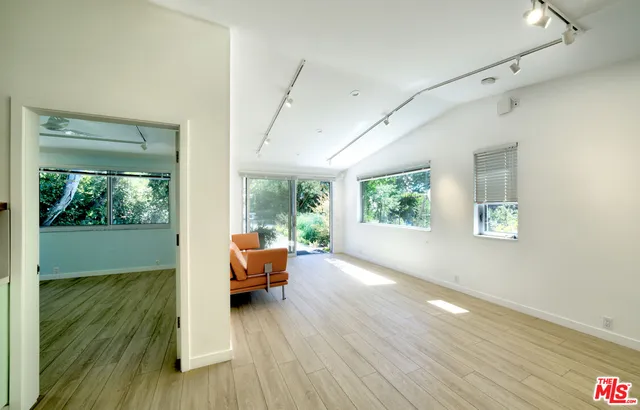 a view of backyard with plants and outdoor seating