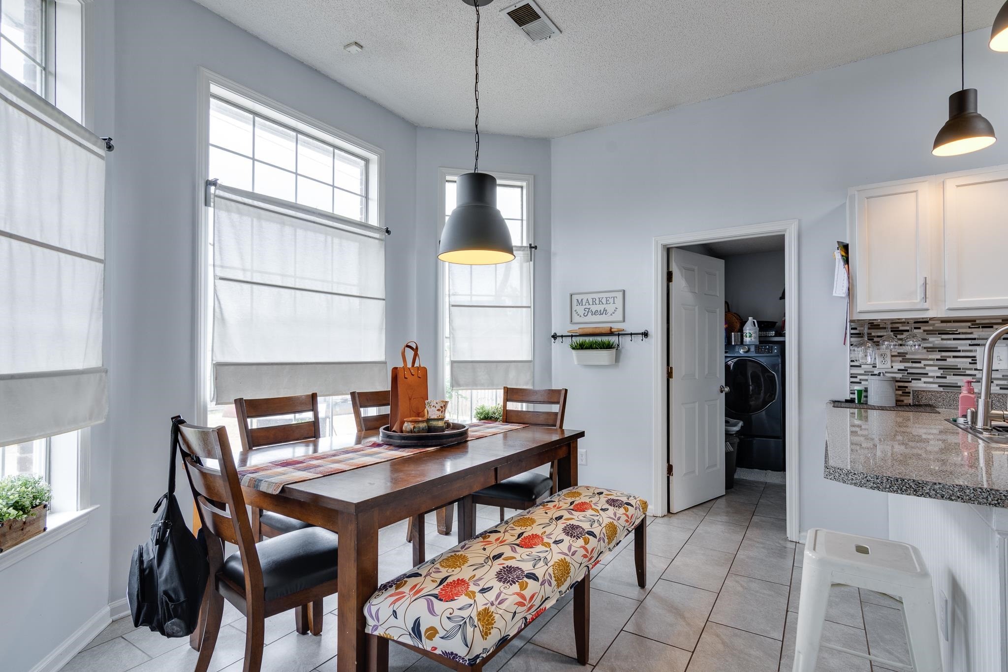 7314 Patsy Circle North Memphis, TN 38125 - Photo 13 of 28 Dining area with light tile patterned floors, plenty of natural light, a textured ceiling, and washer / dryer