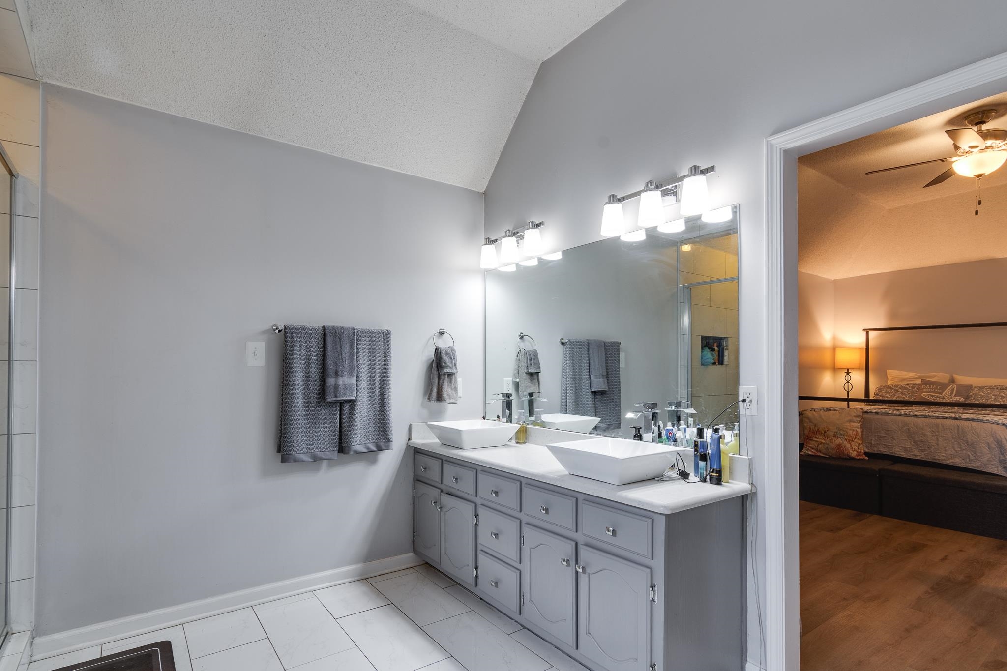 7314 Patsy Circle North Memphis, TN 38125 - Photo 15 of 28 Full bath with vaulted ceiling, double vanity, ensuite bath, a tile shower, and a ceiling fan