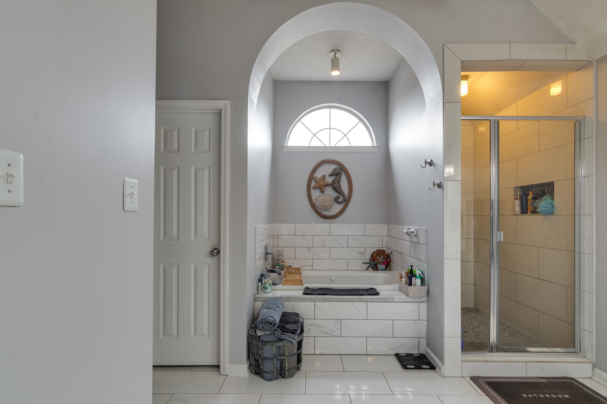 7314 Patsy Circle North Memphis, TN 38125 - Photo 17 of 28 Full bathroom featuring a bath, a stall shower, tile patterned floors, and a textured ceiling