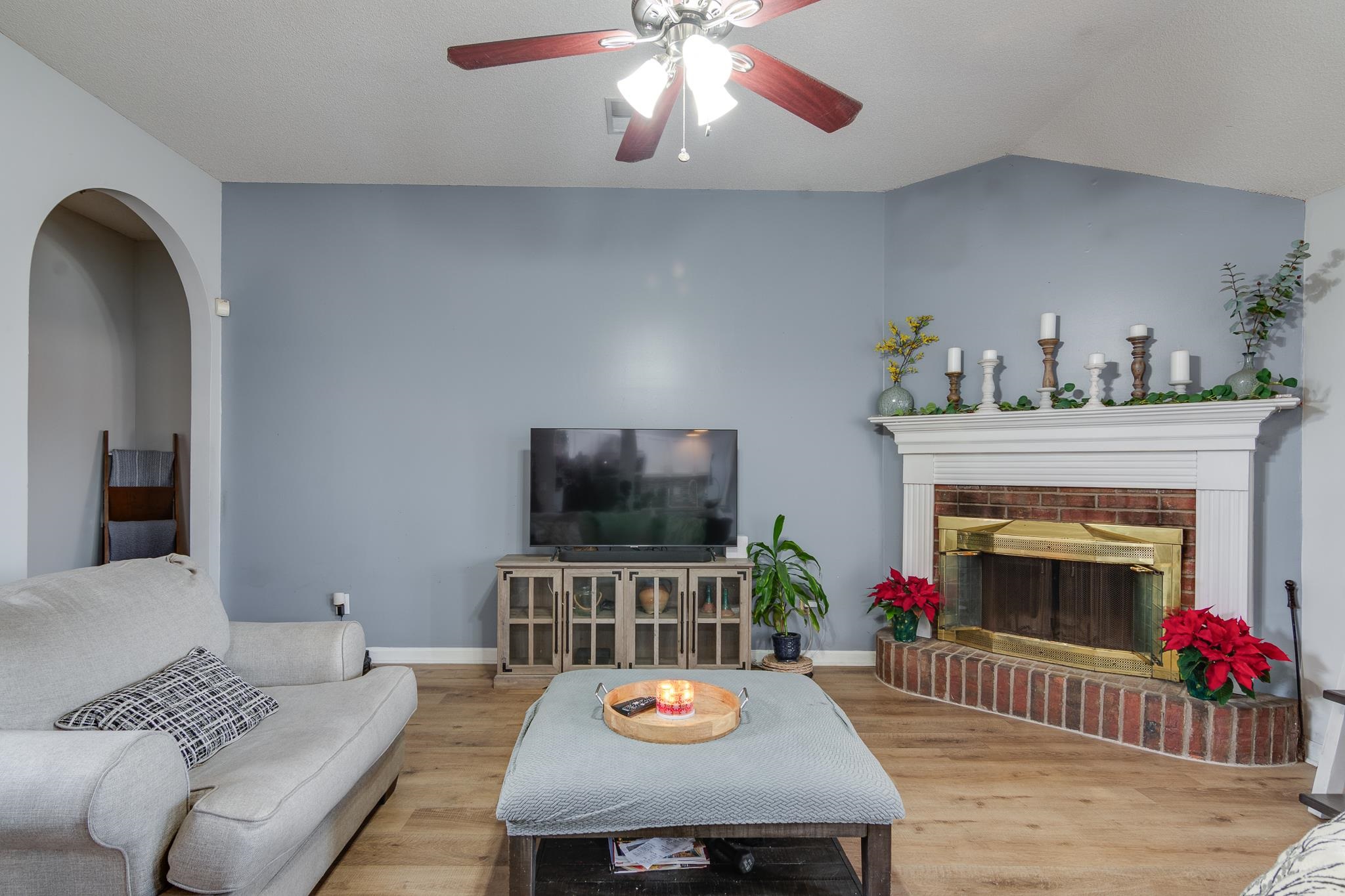 7314 Patsy Circle North Memphis, TN 38125 - Photo 5 of 28 Living area with lofted ceiling, ceiling fan, wood finished floors, and a fireplace