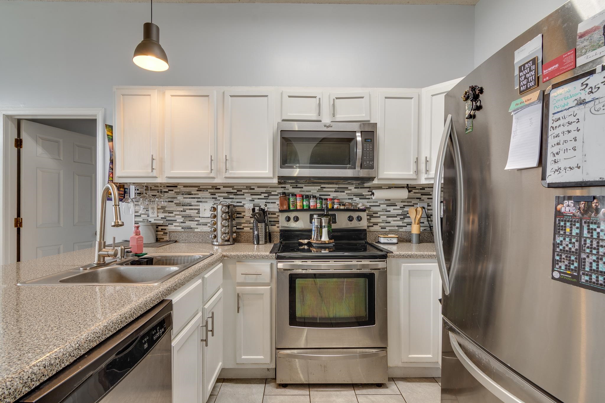 7314 Patsy Circle North Memphis, TN 38125 - Photo 10 of 28 Kitchen featuring stainless steel appliances, white cabinets, and backsplash