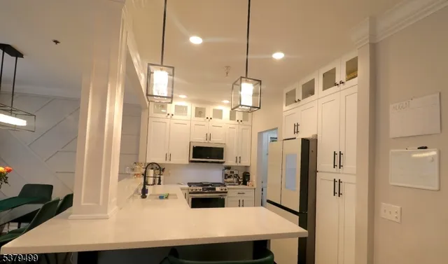 a kitchen with stainless steel appliances a refrigerator sink and stove