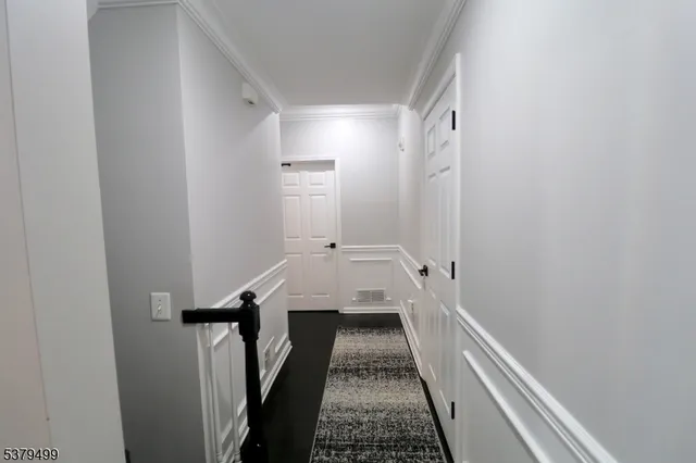 a view of a bathroom with a sink and a wooden floor