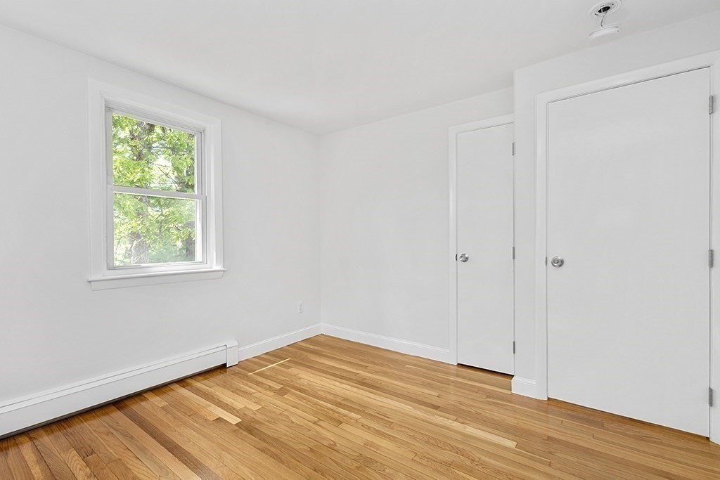 117 Oak Ridge Drive Ayer, MA 01432 - Photo 16 of 26 wooden floor in an empty room with a window