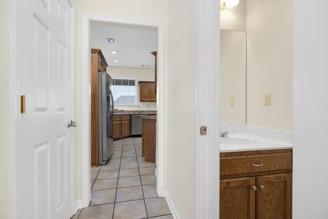 a spacious bathroom with a granite countertop sink and a mirror