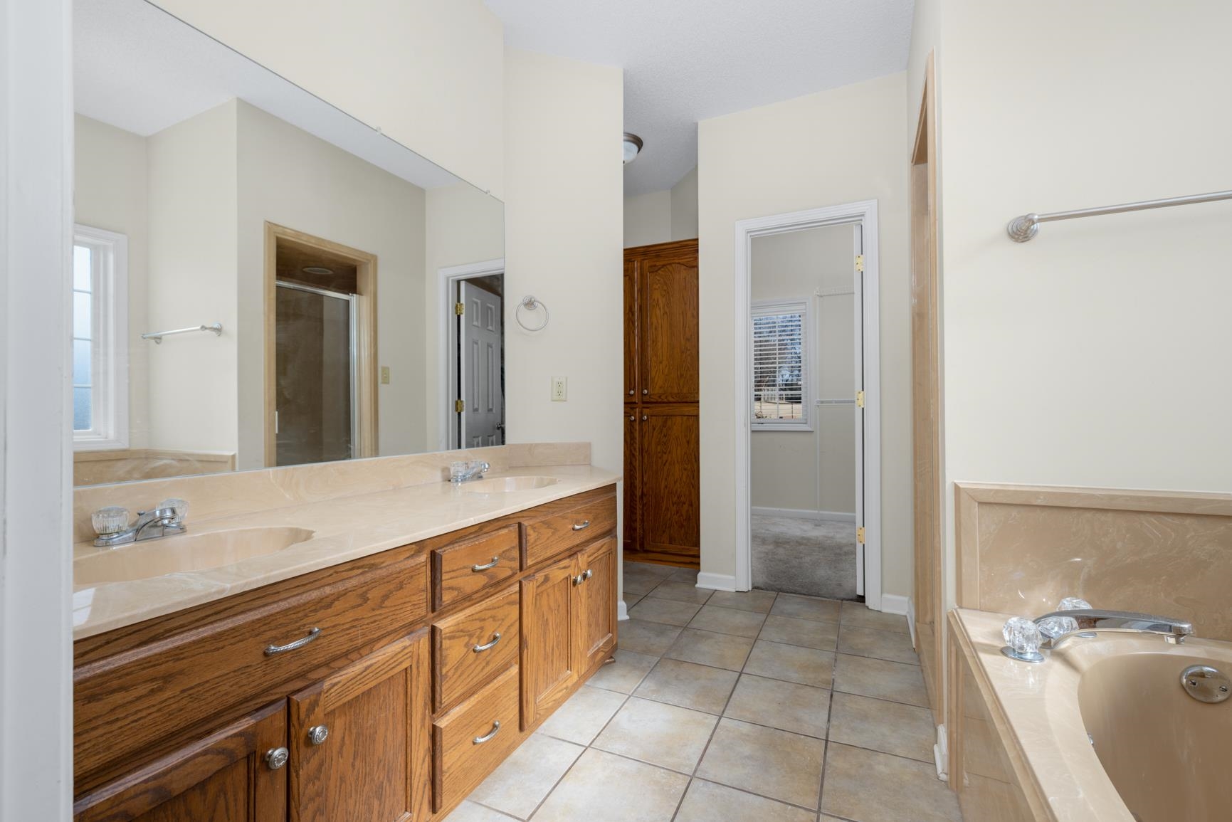 471 Farmer Trail Atoka, TN 38004 - Photo 19 of 35 a spacious bathroom with a granite countertop sink and a mirror