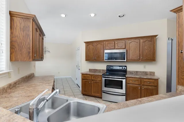 a view of a kitchen with a sink and a refrigerator