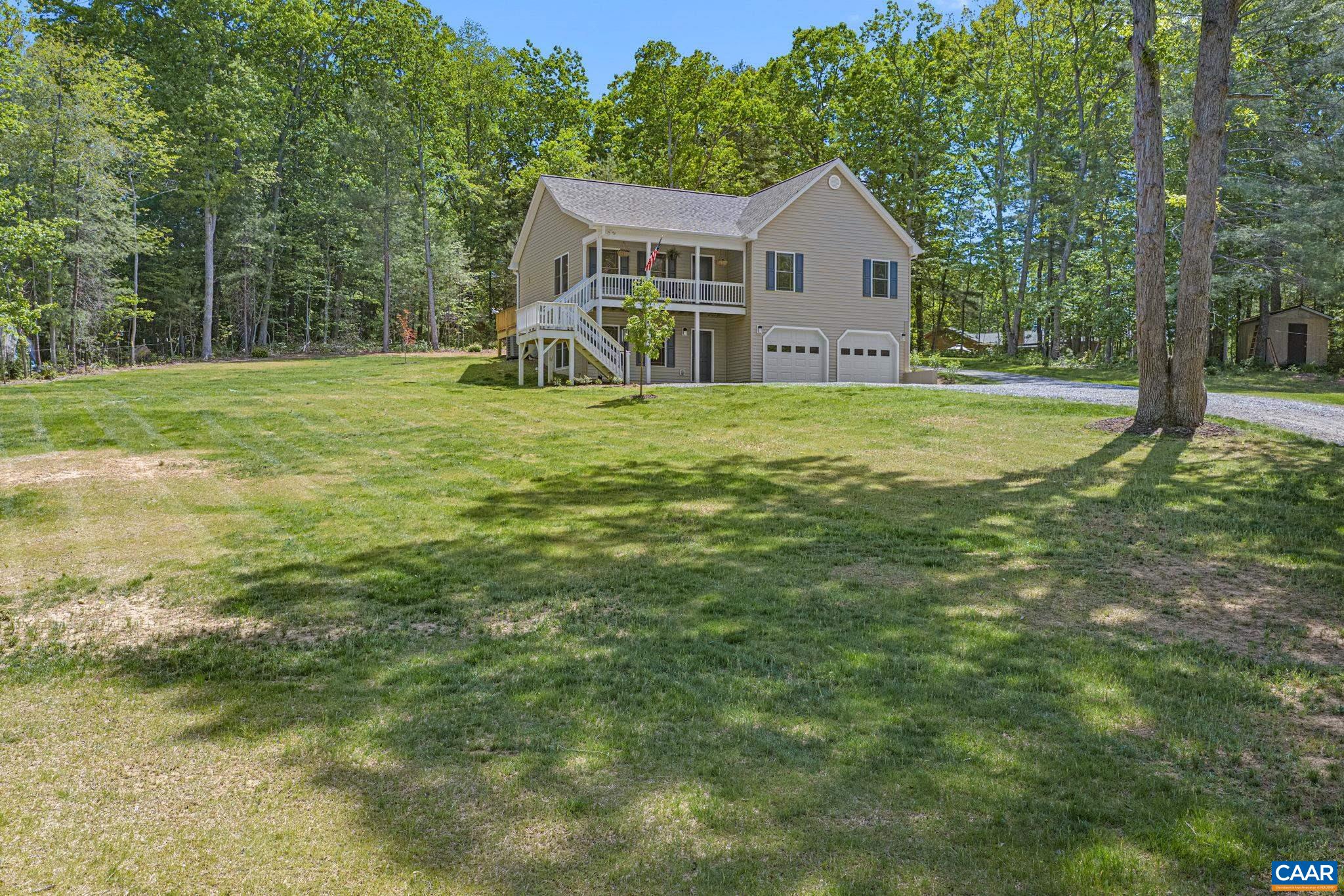 230 Fox Hollow Road Ruckersville, VA 22968 - Photo 3 of 42 a view of a house with a big yard and large trees