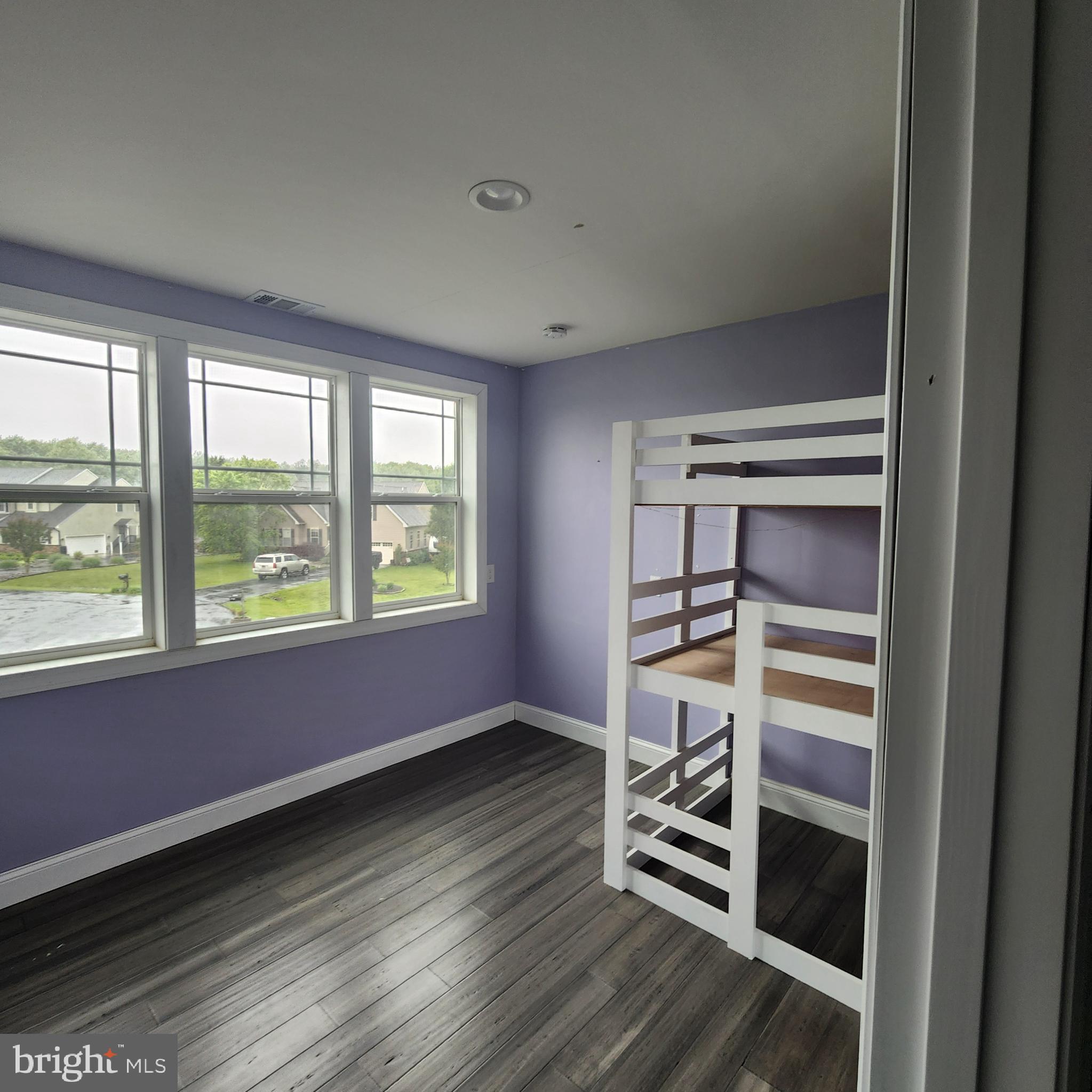 15050 Sandpiper Road Milton, DE 19968 - Photo 14 of 25 a view of an empty room with a window and wooden floor