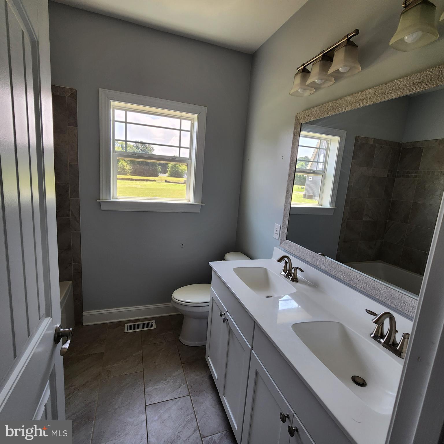 15050 Sandpiper Road Milton, DE 19968 - Photo 17 of 25 a bathroom with a sink a toilet and mirror