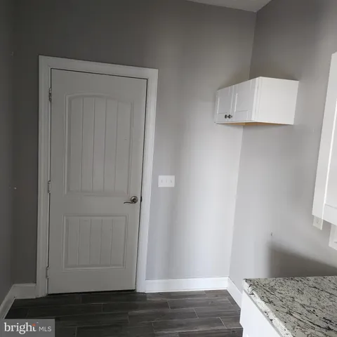 a view of room with wooden floor and cabinet