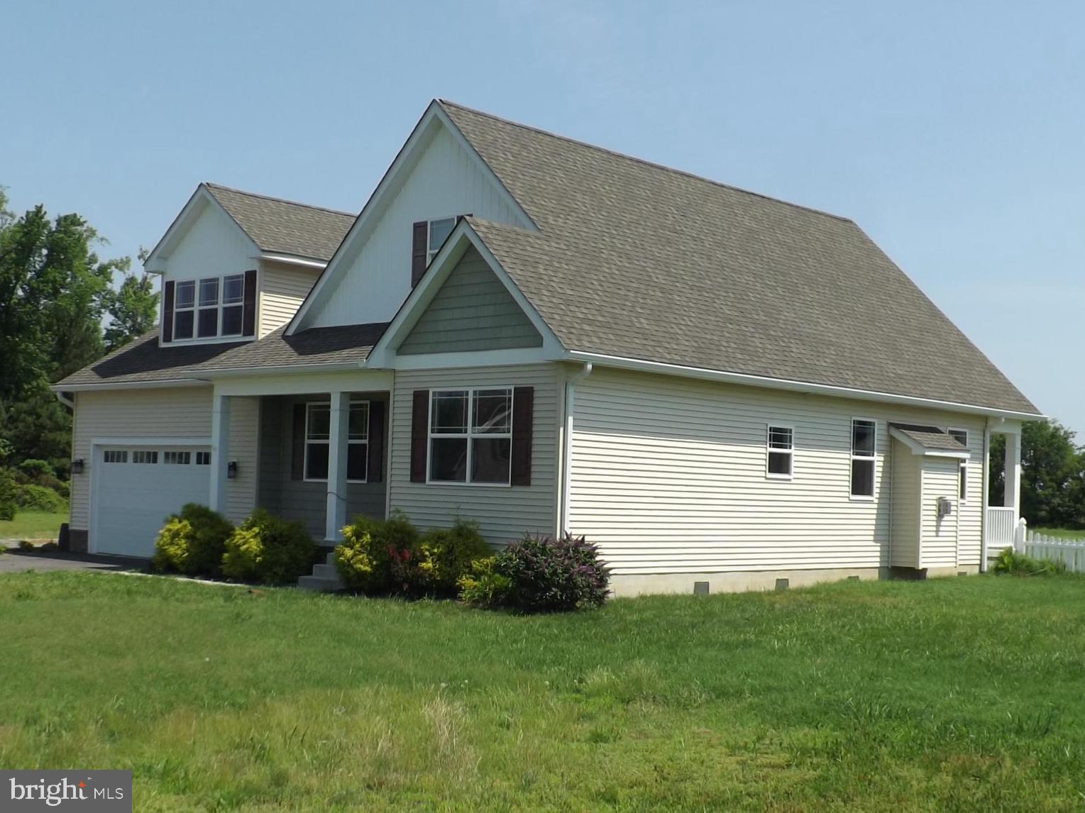 15050 Sandpiper Road Milton, DE 19968 - Photo 2 of 25 a front view of a house with a yard