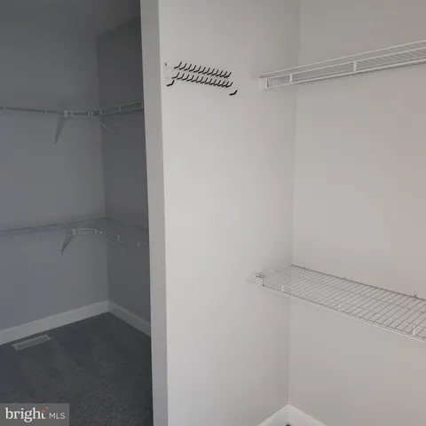 a view of a house with a small yard and fence