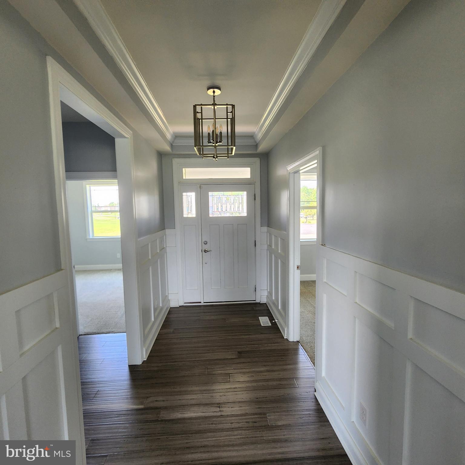 15050 Sandpiper Road Milton, DE 19968 - Photo 4 of 25 a view of a hallway view with wooden floor and staircase