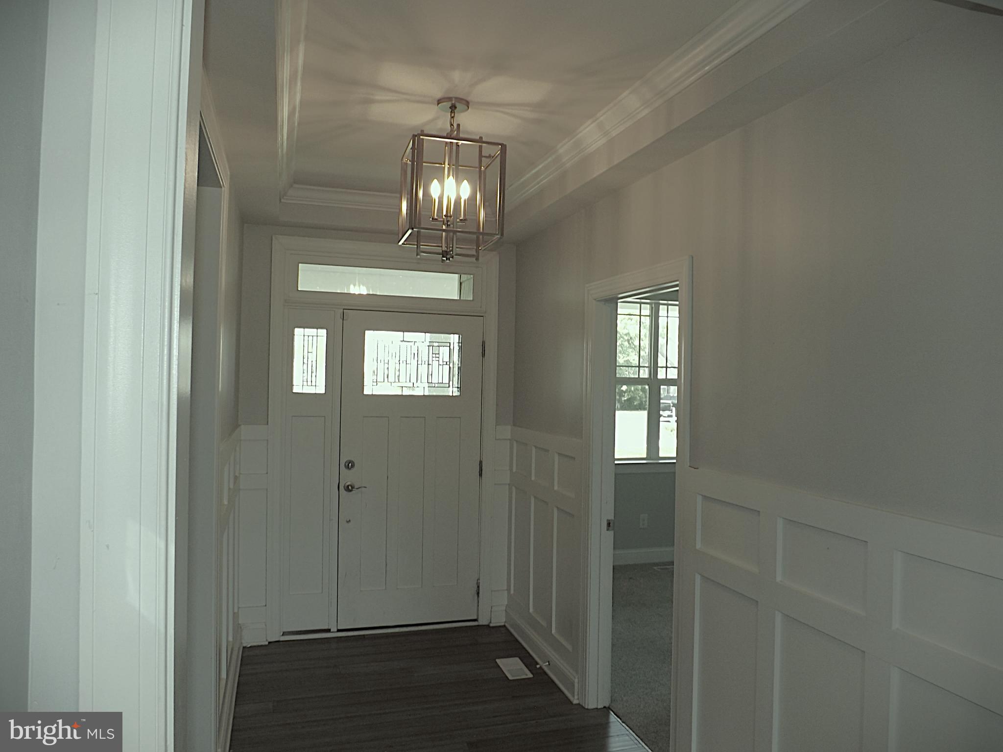 15050 Sandpiper Road Milton, DE 19968 - Photo 5 of 25 a view of a hallway with wooden floor and staircase