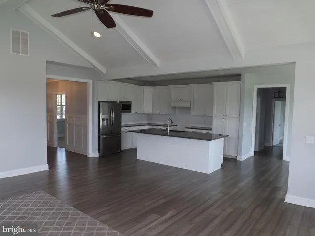 a view of kitchen with sink and wooden floor