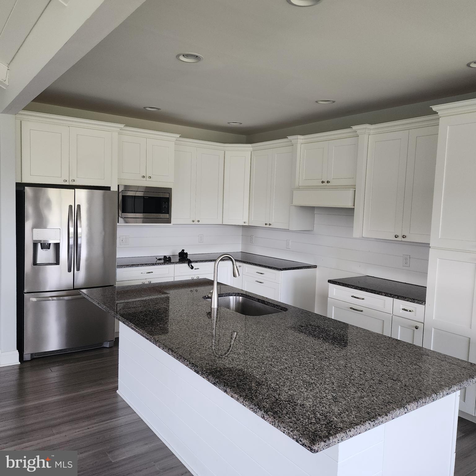 15050 Sandpiper Road Milton, DE 19968 - Photo 8 of 25 a kitchen with stainless steel appliances granite countertop a sink stove and refrigerator