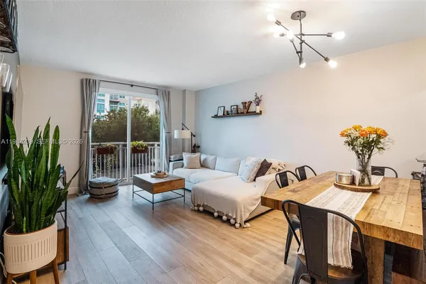 a living room with furniture and a potted plant