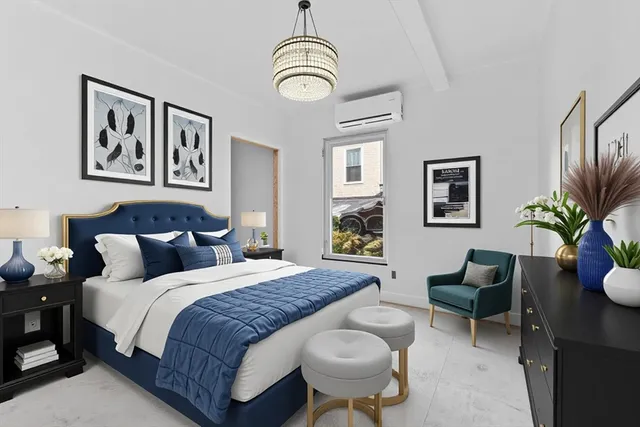 a bedroom with bed and a chandelier