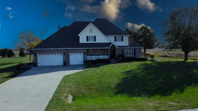 a front view of a house with a garden and yard