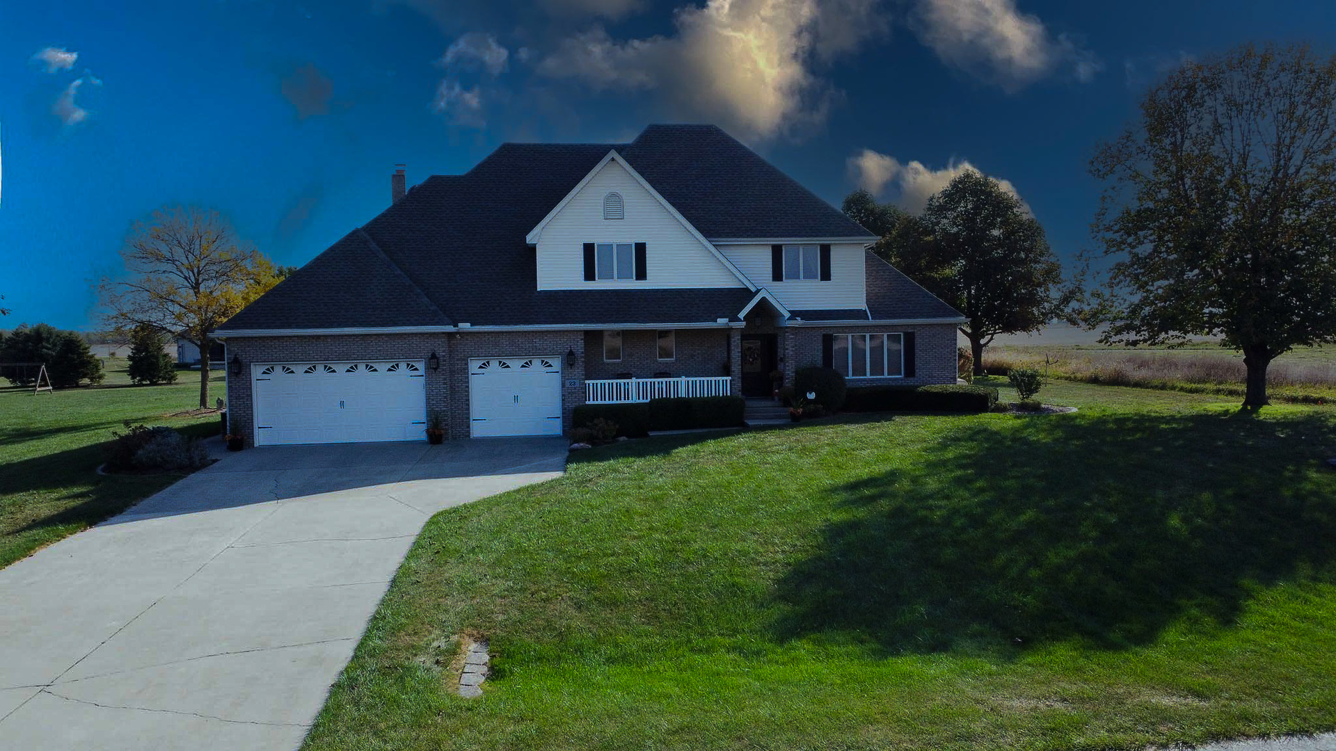 a front view of a house with a garden and yard