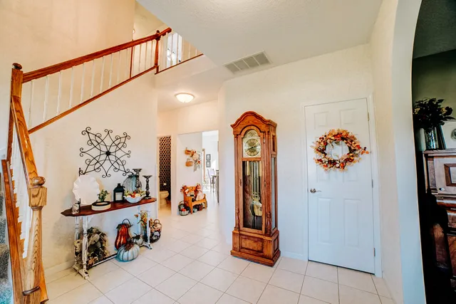 a living room with furniture kitchen view and a window